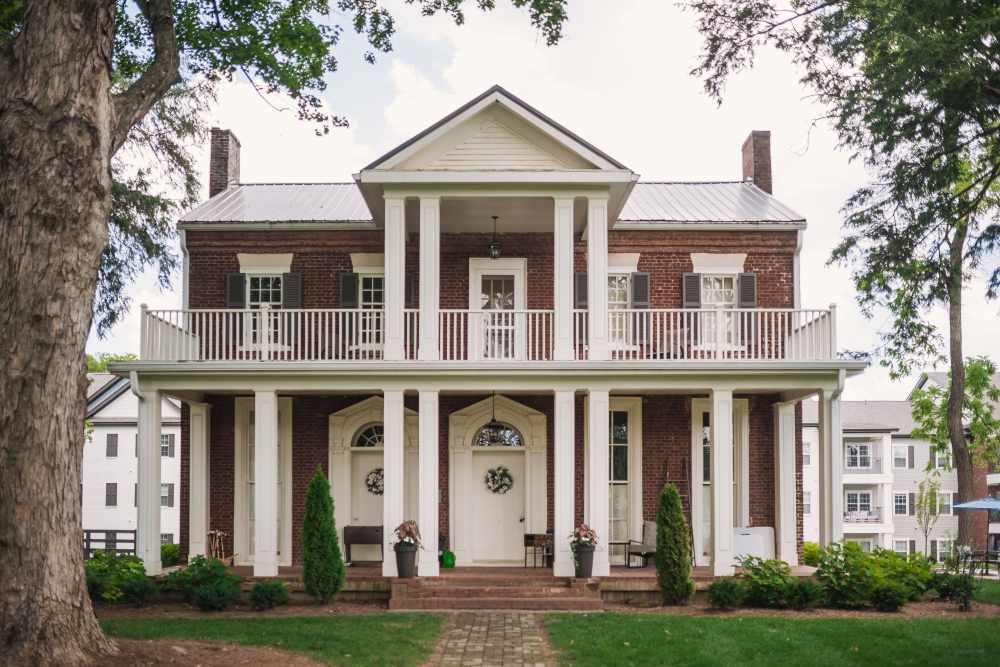 Historic mansion clubhouse with columned porches at Springfield Apartments in Murfreesboro, Tennessee