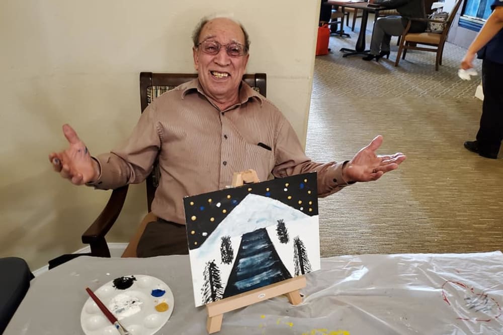 A resident showing off his painting at Sunlit Gardens in Alta Loma, California
