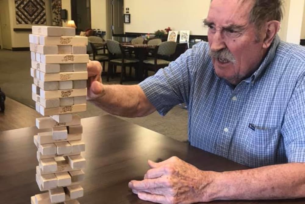 A resident playing Jenga at The Retreat at Sunriver in St. George, Utah