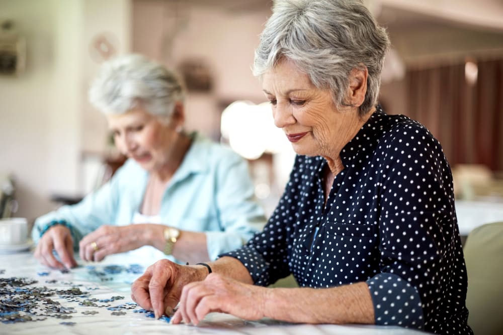 Two residents doing a puzzle at a Randall Residence community