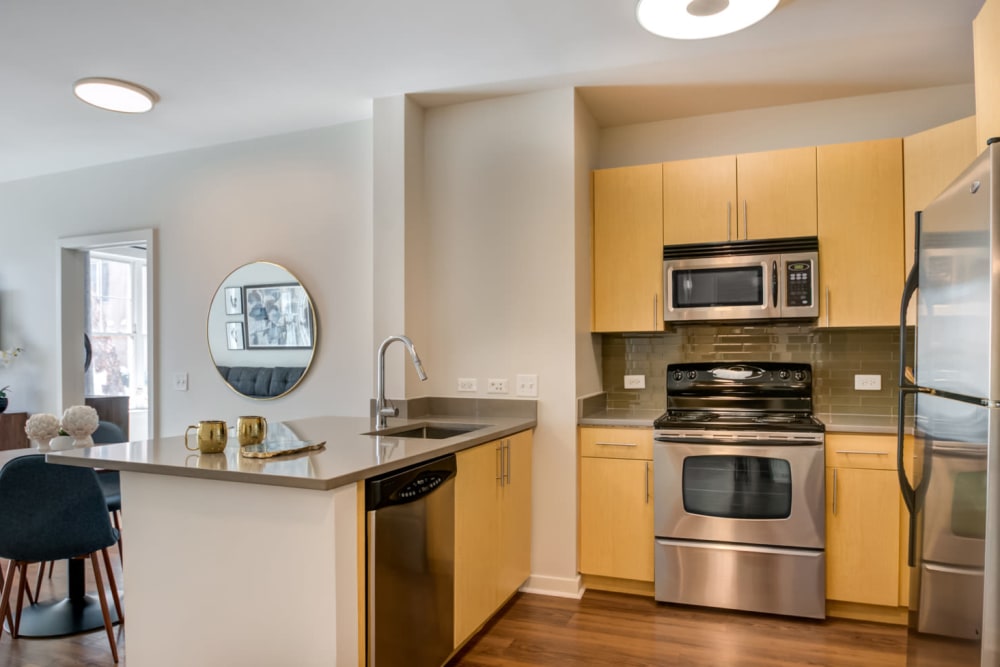 Open layout kitchen and dining space at Sofi at Morristown Station in Morristown, New Jersey