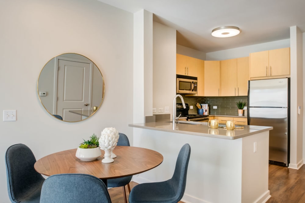 Well-decorated model home's kitchen and dining area at Sofi at Morristown Station in Morristown, New Jersey