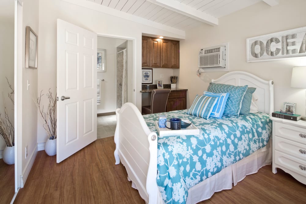 Model bedroom with queen size bed at The Meridian At Bella Mar