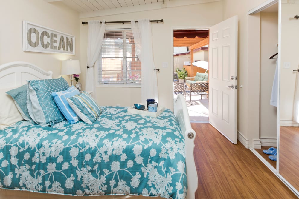 Model bedroom with queen size bed at The Meridian At Bella Mar