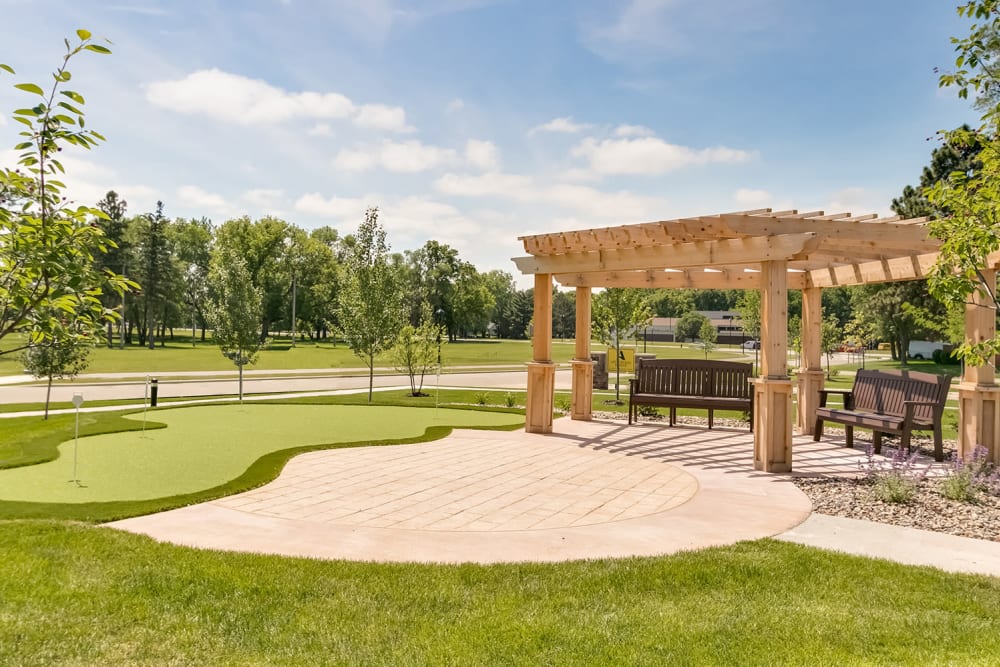 Sitting area with benches at Applewood Pointe of Champlin at Mississippi Crossings in Champlin, Minnesota. 
