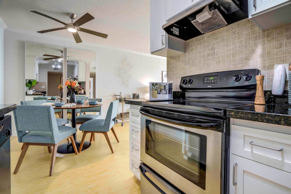 Modern kitchen with stylish cabinetry and stainless steel appliances in a model home at Sofi Redwood Park in Redwood City, California