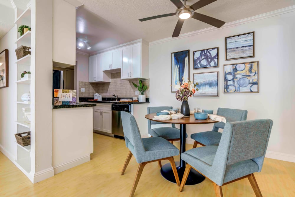 Dining area with a ceiling fan overhead in a model home at Sofi Redwood Park in Redwood City, California