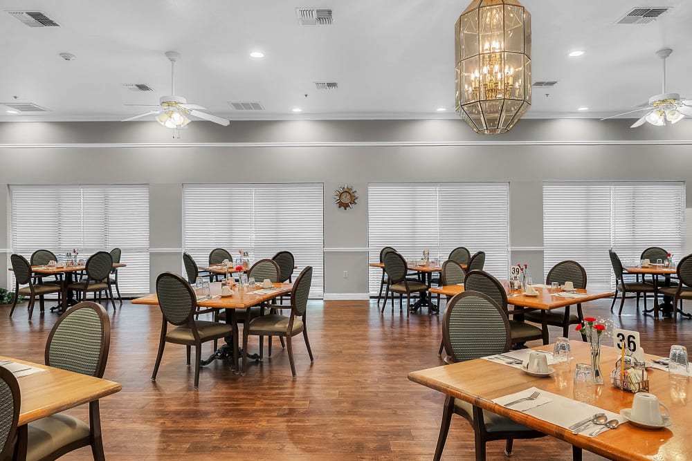 Dining room set for meals with tables and chairs at Spring Oaks