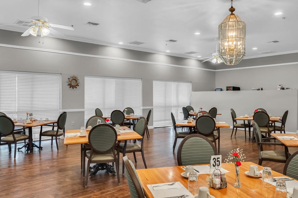 Dining room set for meals with tables and chairs at Spring Oaks