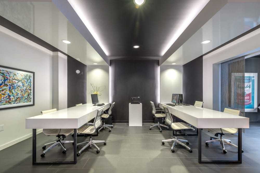 Business center with computers and a printer for resident use at Olympus at Ross in Dallas, Texas