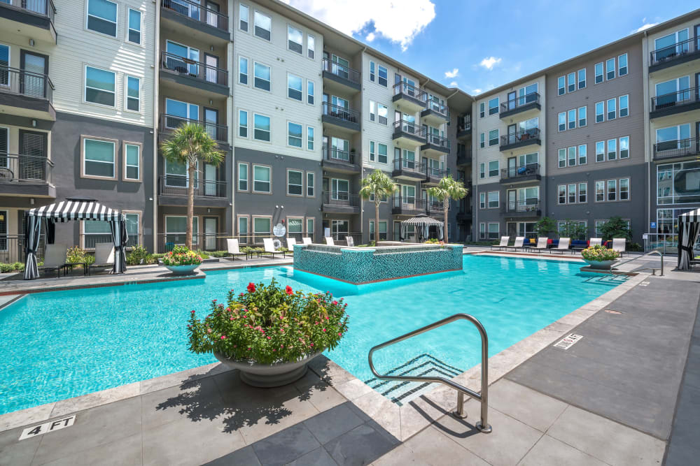Swimming pool area on a beautiful day at Olympus at Ross in Dallas, Texas