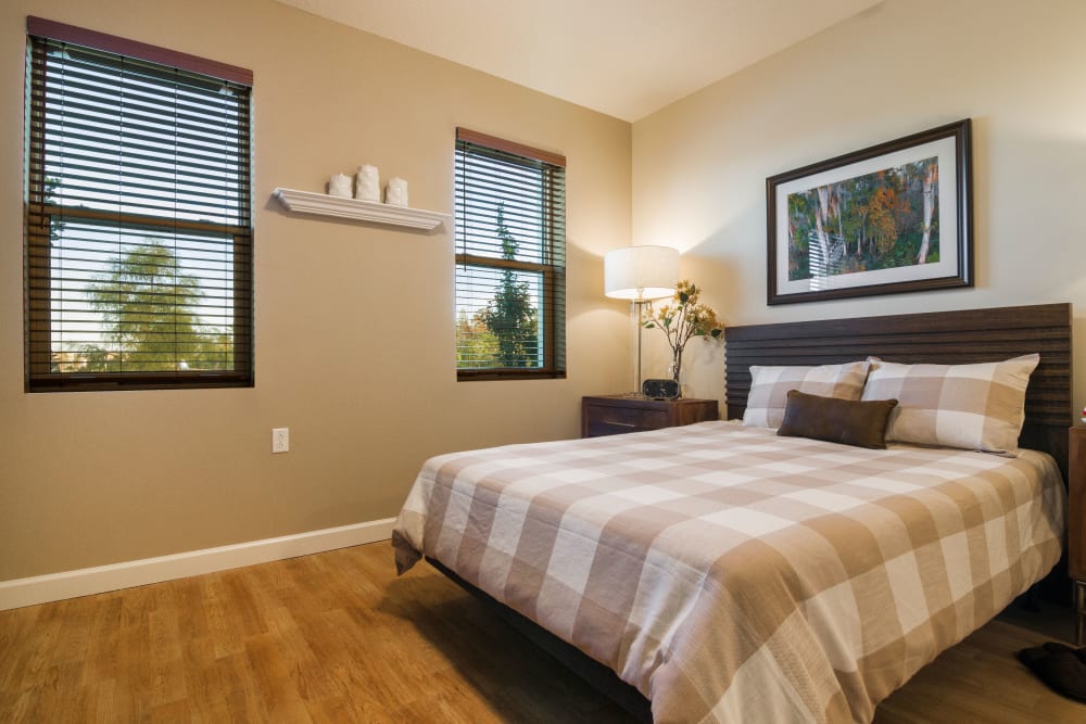 Resident bedroom with windows at CERTUS Premier Memory Care Living in Vero Beach, Florida. 