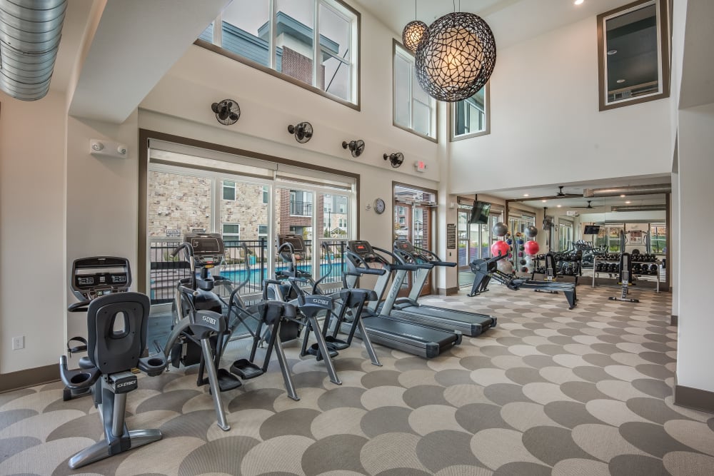 Fully equipped fitness center at Enclave at Woodland Lakes in Conroe, Texas