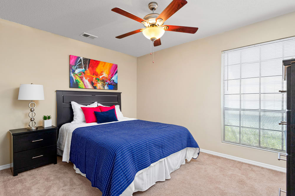 Bedroom with large window at Stoneybrook Apartments and Townhomes