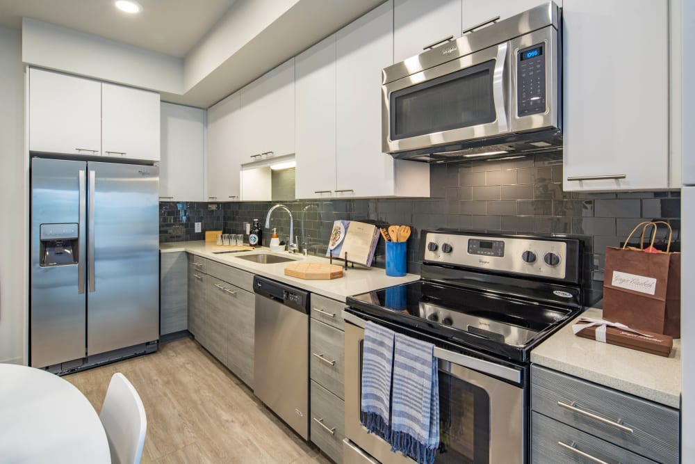 Stainless-steel appliances and quartz countertops in a model home's kitchen at EVIVA Midtown in Sacramento, California