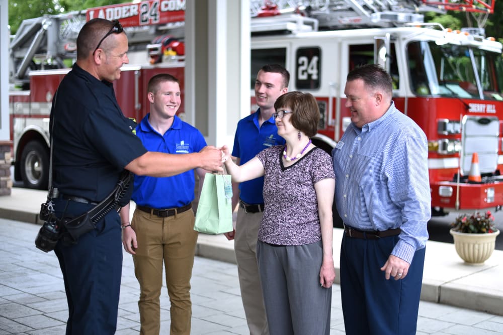 Community executive director shaking hands with firefighter