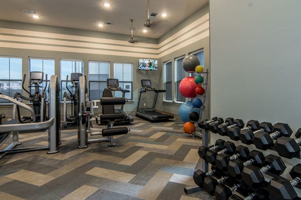 Free weights at Enclave at Westport's fitness center in Roanoke, Texas