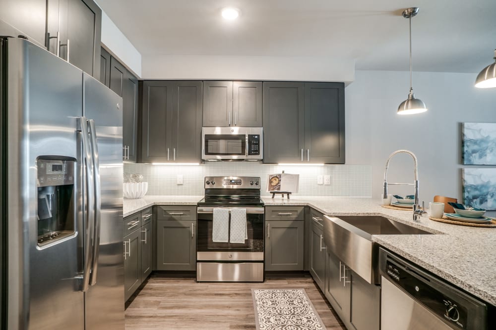 Kitchen with stainless steel appliances at One90 Firewheel in Garland, Texas