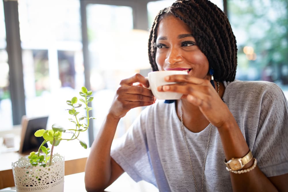 Resident drinking coffee at Three77 Park in Fort Worth, Texas