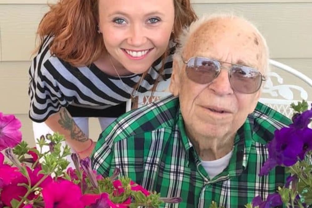 Resident and family visit in garden at Holstein Senior Living in Holstein, Iowa.