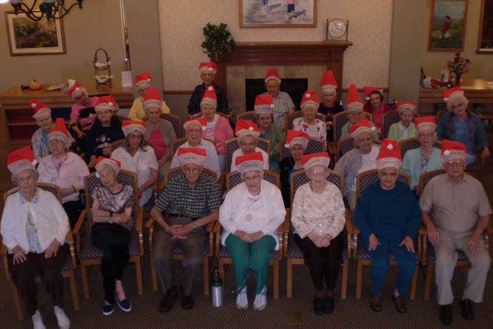 Residents in Santa hats gather for holiday photo at Courtyard Estates at Cedar Pointe in Pleasant Hill, Iowa.