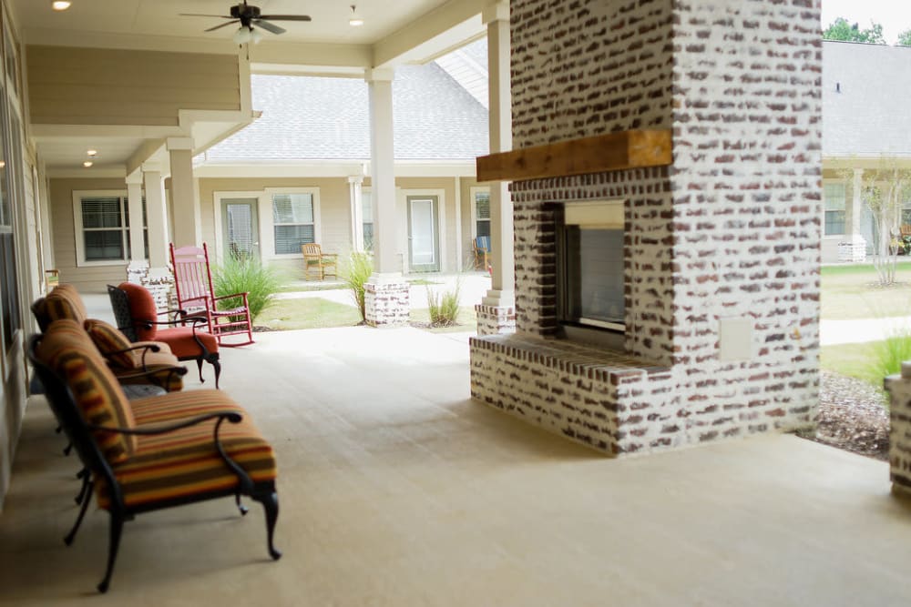 Outdoor living area on porch at The Claiborne at Hattiesburg Assisted Living in Hattiesburg, Mississippi