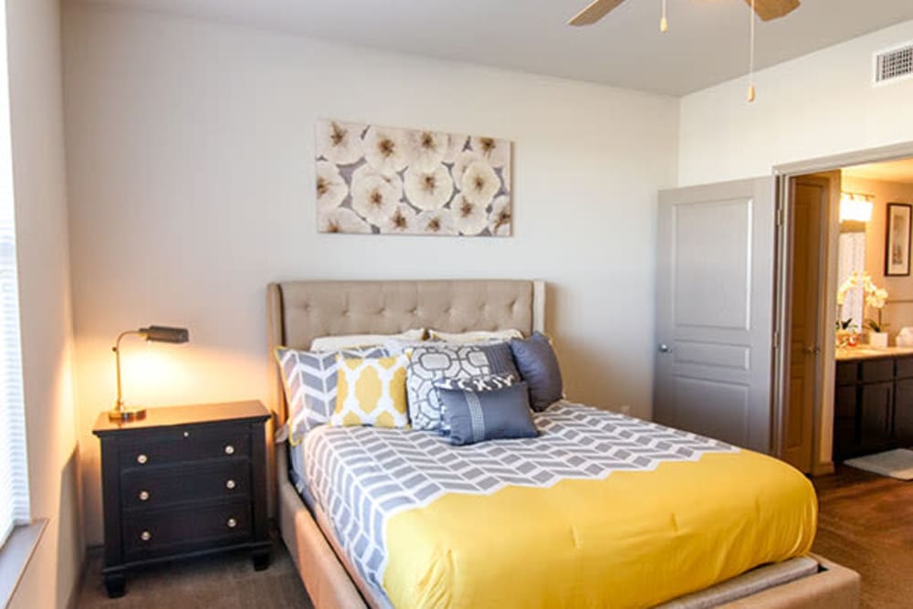 Well-furnished primary bedroom in a model home at Anatole on Briarwood in Midland, Texas