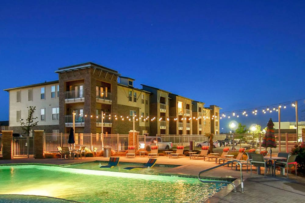 Evening view of the swimming pool with underwater lights on at Anatole on Briarwood in Midland, Texas