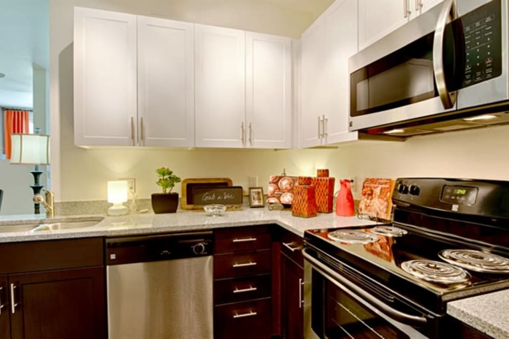 Rich, dark wood cabinetry in a model home's kitchen at Cactus Forty-2 in Phoenix, Arizona