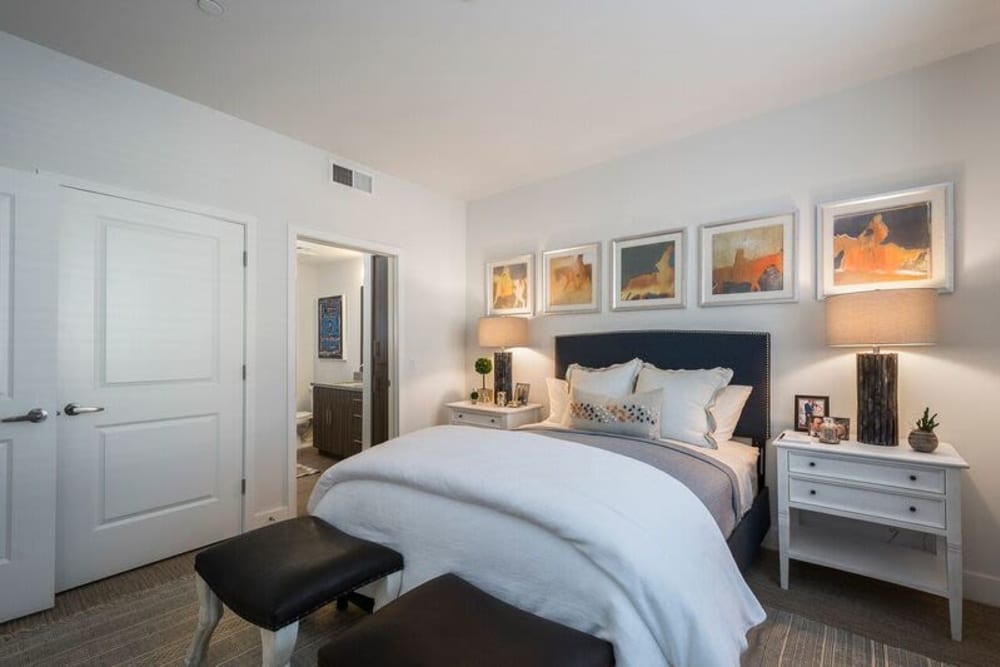 Master bedroom with plush carpeting in a model home at Cadia Crossing in Gilbert, Arizona