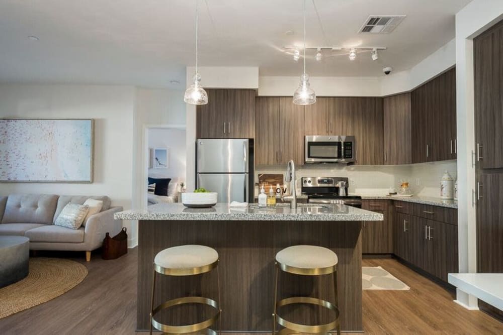 Modern kitchen with a breakfast bar in a model home at Cadia Crossing in Gilbert, Arizona