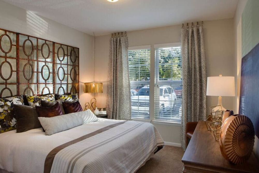Draped windows and fine furnishings in the master bedroom of a model home at Canopy at Citrus Park in Tampa, Florida
