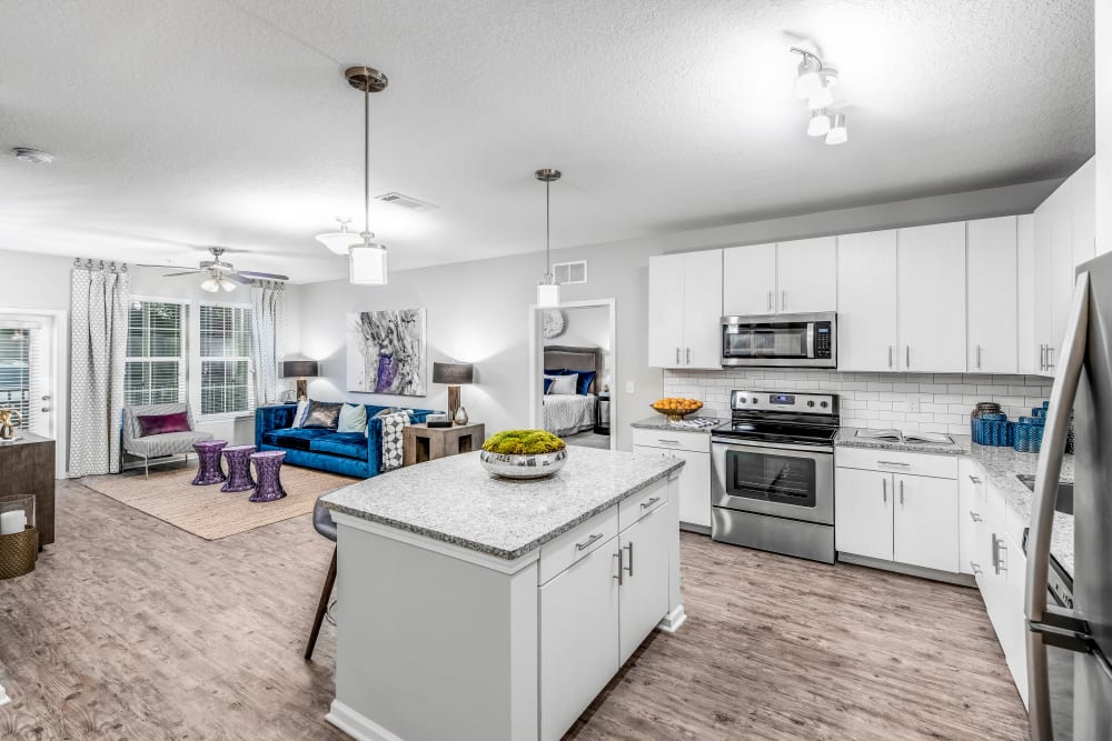 Beautifully designed open-concept layout with hardwood flooring in a model home at Canopy at Citrus Park in Tampa, Florida