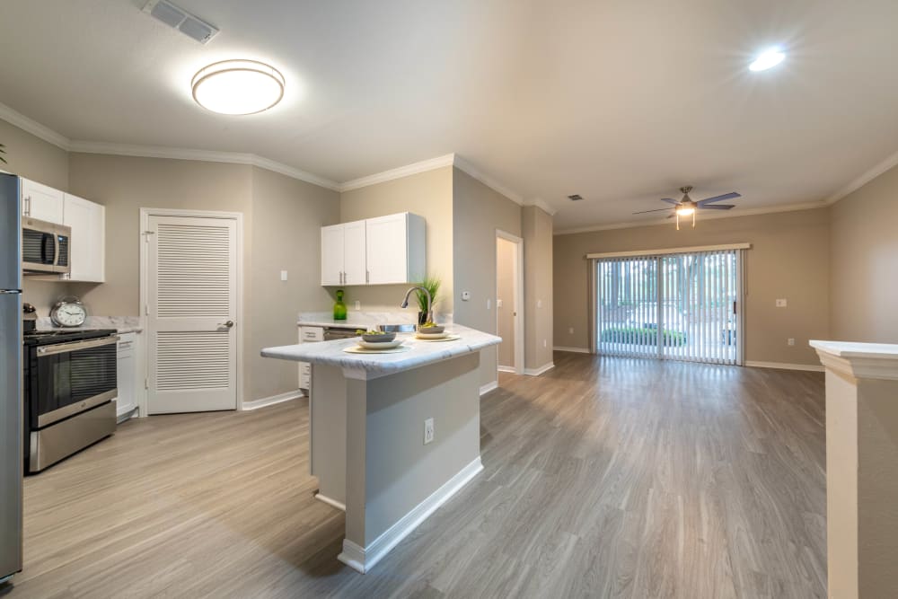 Hardwood flooring throughout the kitchen and living areas of a model home at Cape House in Jacksonville, Florida