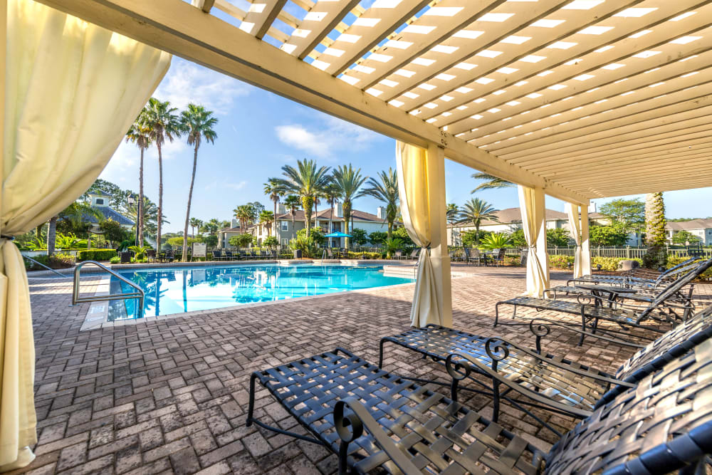Pergola providing partial shade to the lounge chairs by the pool at Cape House in Jacksonville, Florida