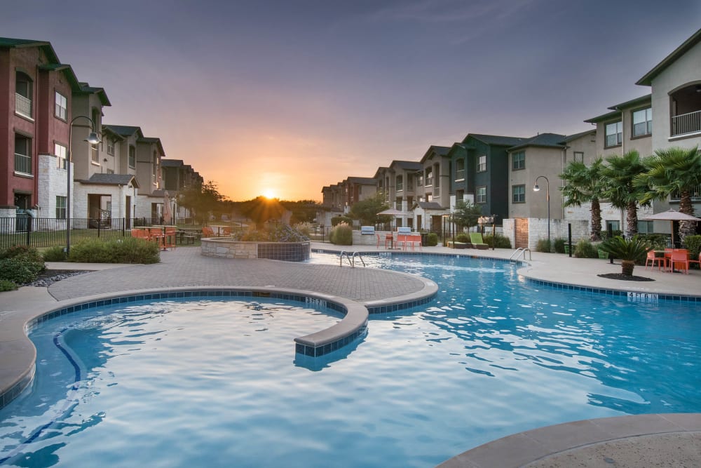 Gorgeous resort-style swimming pool at sundown at Carrington Oaks in Buda, Texas