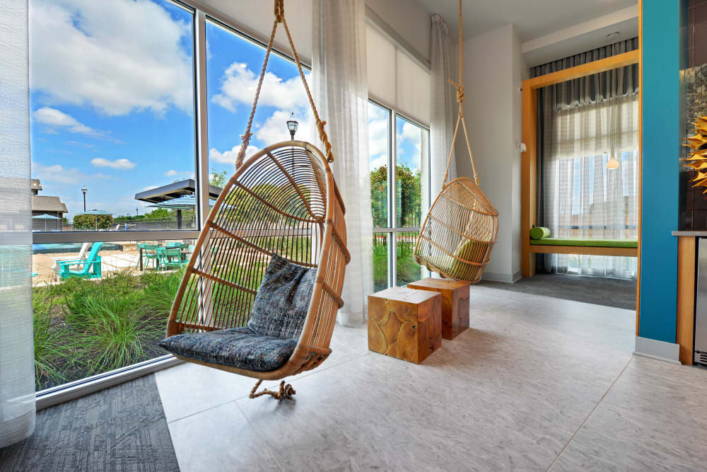 Hanging wicker swing chairs in the clubhouse at Carrington Oaks in Buda, Texas