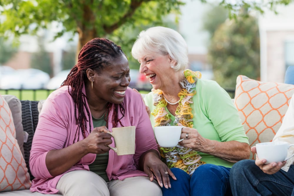 Residents enjoy coffee together on the porch at The Atrium in Rockford, Illinois. 