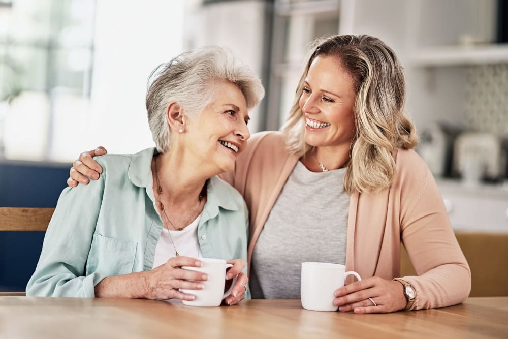 Resident and family member enjoy coffee in apartment at Carrington Assisted Living in Green Bay, Wisconsin.