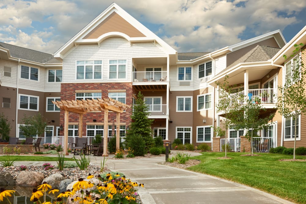 Main entrance with flowers at Applewood Pointe of Bloomington at Valley West in Bloomington, Minnesota. 