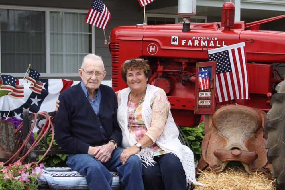 Resident and family member with antique tractor at Lawton Senior Living in Lawton, Iowa. 