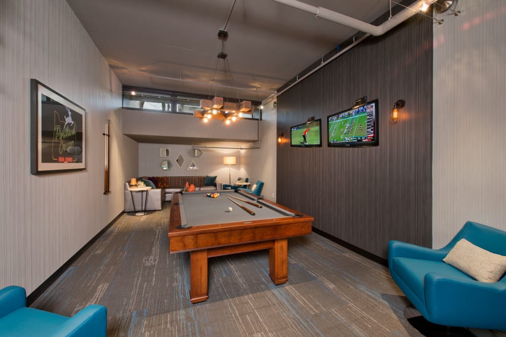 Resident clubhouse with a pool table and comfortable seating at Harrison Tower in Portland, Oregon