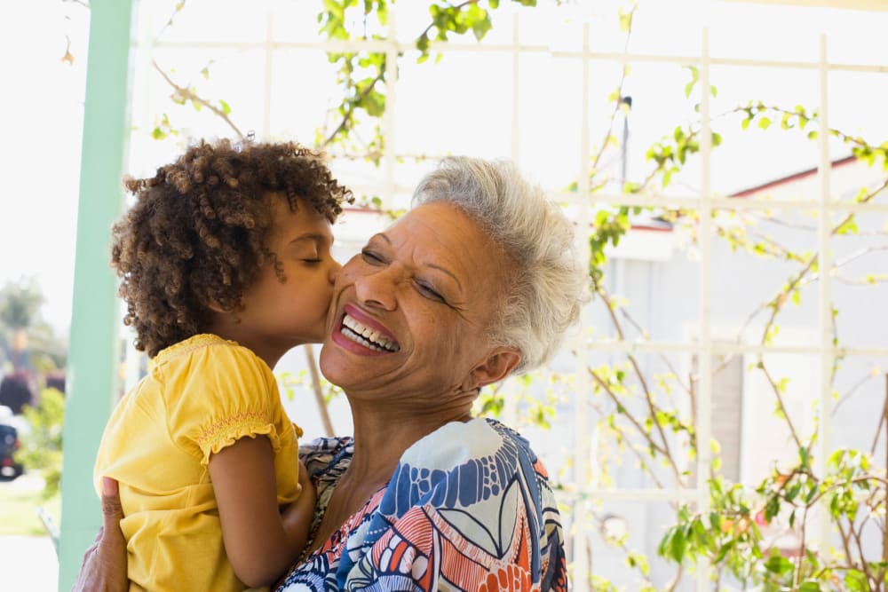 Grandchild hugging grandmother at Milestone Senior Living Woodruff in Woodruff, Wisconsin.