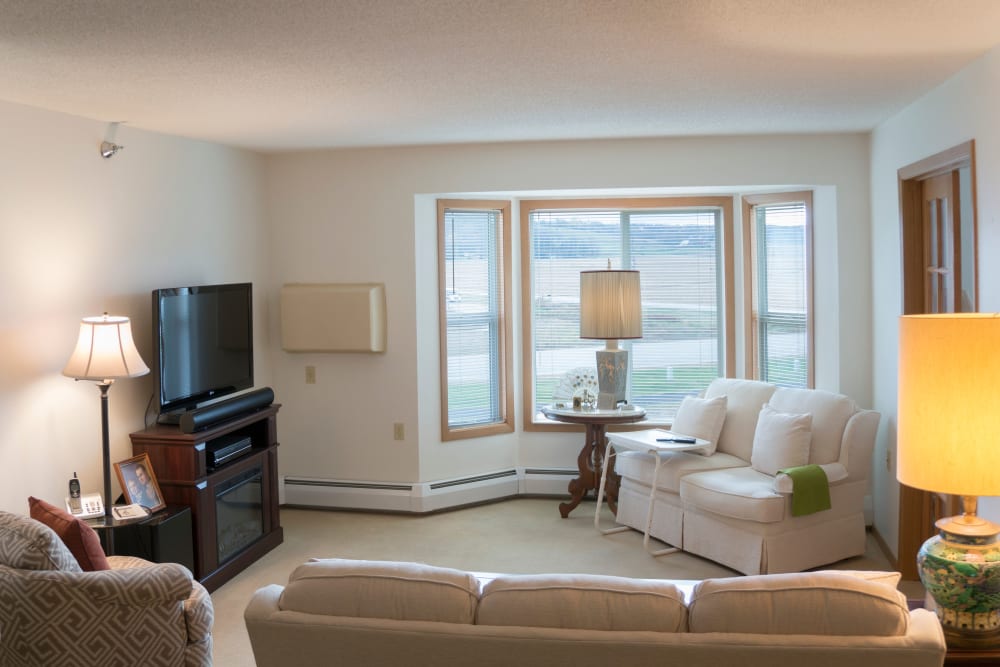 Resident living room with large windows at Meadow Lakes Senior Living in Rochester, Minnesota.