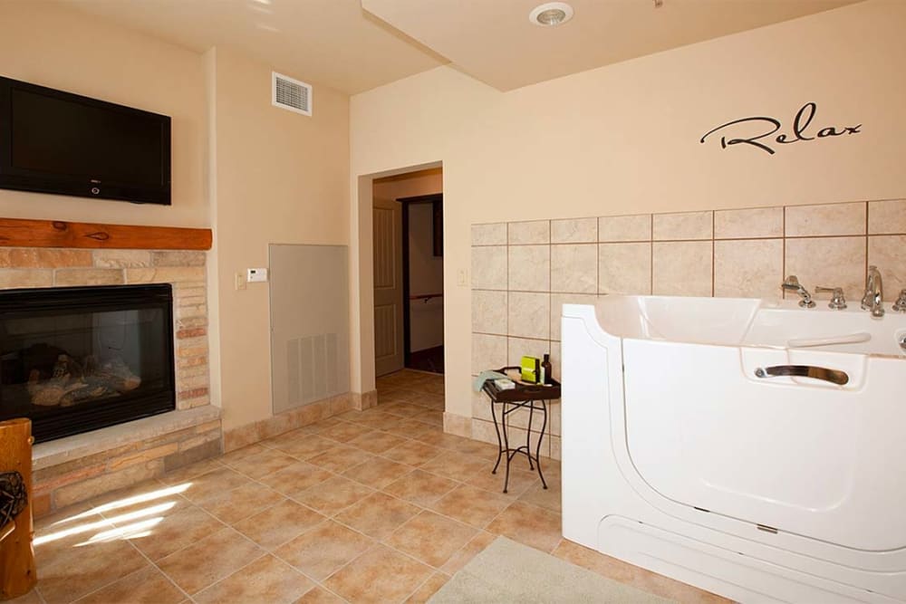 Spa room with fireplace and Jacuzzi tub at Milestone Senior Living Eagle River in Eagle River, Wisconsin.