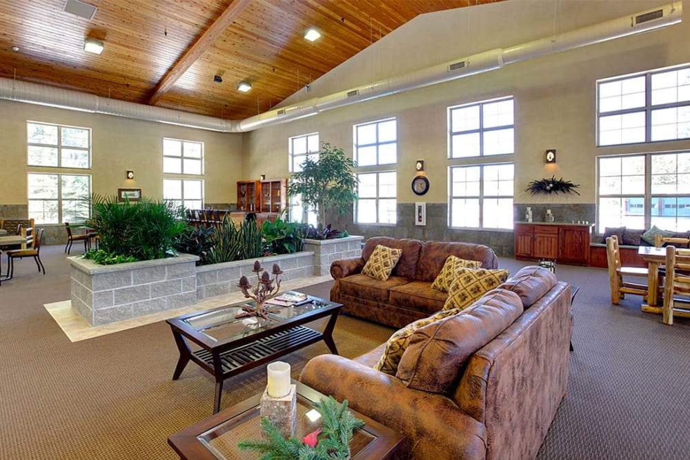 Comfortable lounge seating with vaulted ceilings at Milestone Senior Living Eagle River in Eagle River, Wisconsin.