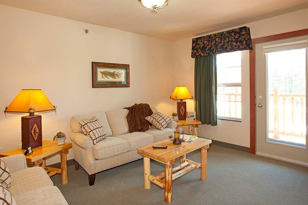 Resident living room with picture windows at Milestone Senior Living Eagle River in Eagle River, Wisconsin.