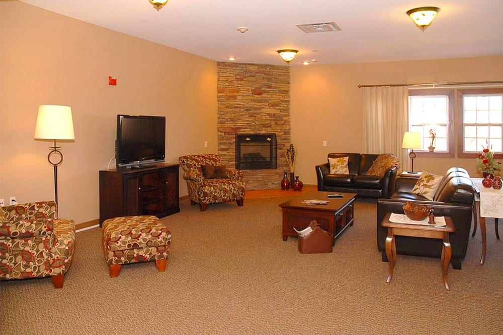Comfortable resident TV room with fireplace at Milestone Senior Living Eau Claire in Eau Claire, Wisconsin.