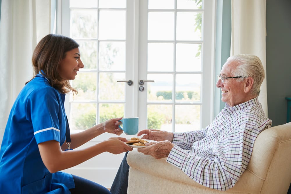 A staff member visits an assisted living resident at Milestone Senior Living Faribault in Faribault, Minnesota. 