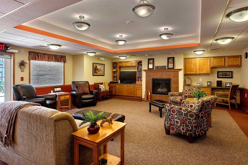 Comfortable lounge with a fireplace at Milestone Senior Living Hillsboro in Hillsboro, Wisconsin.